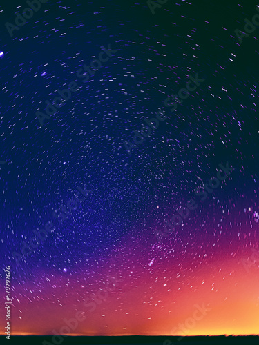 Colourful Night Starry Sky Gradient. Night Dark Blue Sky Glowing Stars Background Backdrop With Sky Gradient. Amazing Night View Sky. Bright Purple  Yellow And Orange Colors. Copy Space.