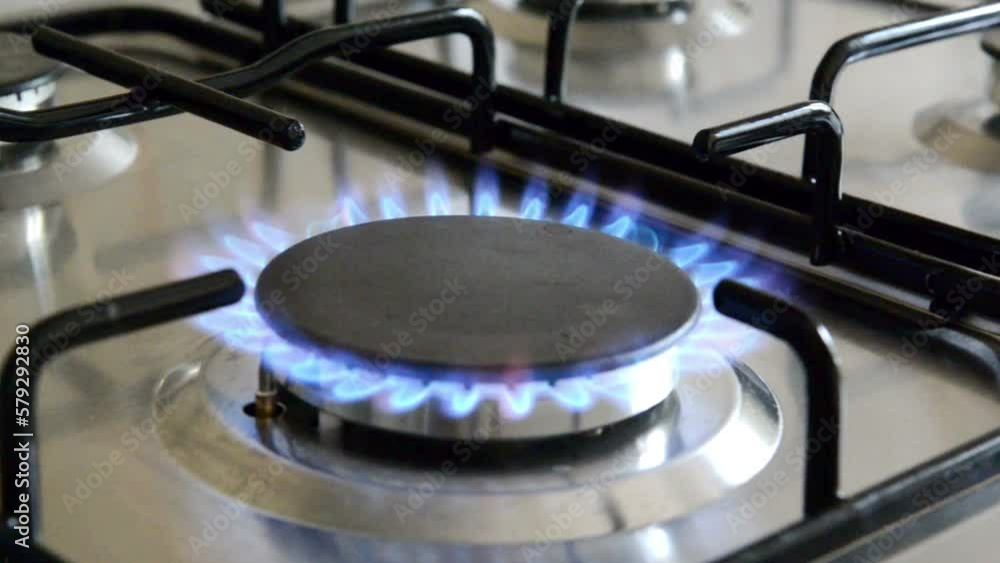 Gas burns in gas burner in the kitchen. Natural gas consumption and savings, cooking using a gas stove Gas burns in gas burner in the kitchen. Natural gas consumption and savings, cooking using a gas stove