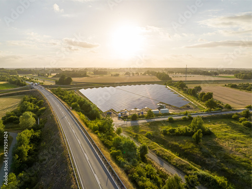 drone shot of a solar park on a street in the countryside