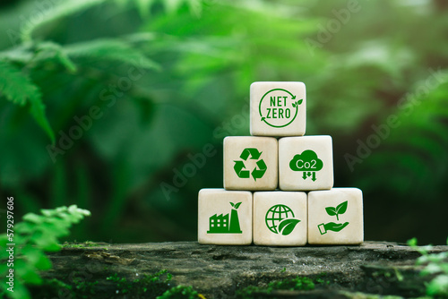 Carbon neutral and net zero concept natural environment Climate-neutral long-term strategy greenhouse gas emissions targets Wooden block with green icon and nature backgroung.