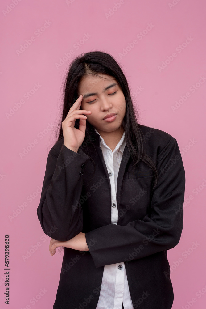 A frustrated and stressed out woman does not know what to do, wavering on her decision. Shrugging, feeling lost. Isolated on a light pink background. A frustrated and stressed out woman does not know what to do, wavering on her decision. Shrugging, feeling lost. Isolated on a light pink background.