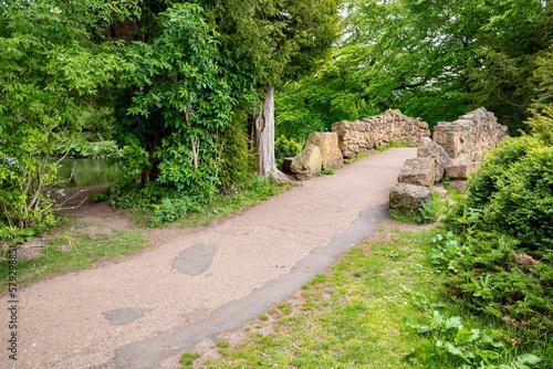 stone bridge and path through woodland at Country Park photo