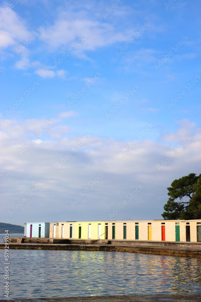 Colorful changing cabins, landmark on beach Jadrija, in Sibenik, Croatia.