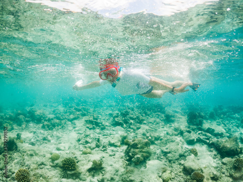 woman snorkeling in clear tropical sea