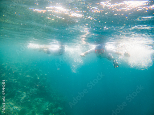 couple snorkeling in clear tropical sea