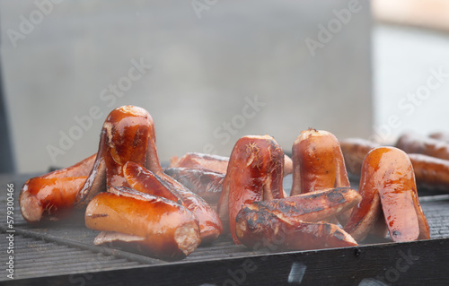 Grilling of sausages and kielbasa at the farmers street food market in Prague photo