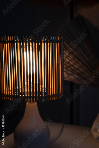 a wooden lamp shines on the table