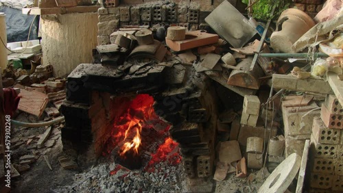 Thanh Ha pottery village in Quang Nam province, Vietnam. A chaotic scene of traditional pottery making with wood ovens burning. photo