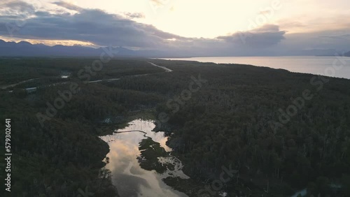 Aerial Sunrise Drone Above Patagonian Forest, Cami Fagnano Lake in Tolhuin, Tierra del Fuego, Huge Landscape of Trees and Pristine Water in Unpolluted Area photo