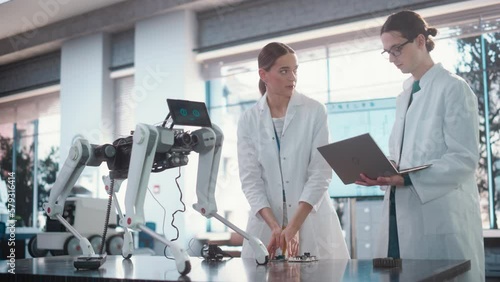 Wallpaper Mural Male Project Manager and Female Machinery Operator Collaborate on a Mobile Robot Animal Project, Using Laptop Computer. Two Professional Engineers Brainstorming, Discussing Futuristic AI Pet Torontodigital.ca
