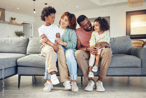 Black family, love and bond on a sofa, happy and smile while talking and enjoying a morning in their home. Relax, children and parents on couch together, embrace and loving in living room on weekend