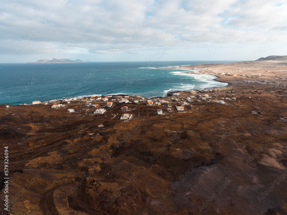 Aerial photos of Calhau, a village located near an inactive volcano in Sao Vicente Island, Cabo Verde, offer a unique perspective of the towering volcanic landscape, rugged terrain, and vibrant coasta Aerial photos of Calhau, a village located near an inactive volcano in Sao Vicente Island, Cabo Verde, offer a unique perspective of the towering volcanic landscape, rugged terrain, and vibrant coasta