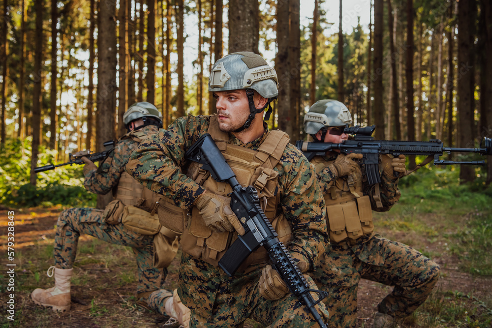 Soldier fighters standing together with guns. Group portrait of US army elite members, private military company servicemen, anti terrorist squad