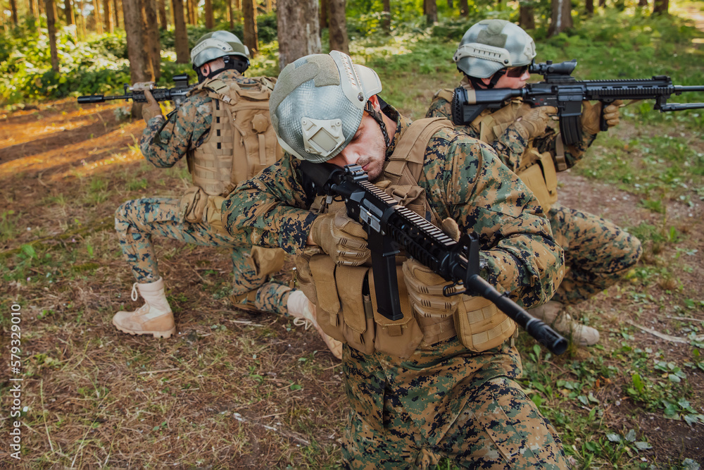 Fototapeta premium Soldier fighters standing together with guns. Group portrait of US army elite members, private military company servicemen, anti terrorist squad