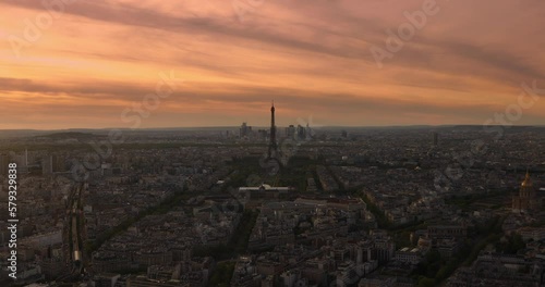 Panoramic aerial view of Paris cityscape with Eiffel Tower and major business district of La Defence in background As the video view of golden sun sets behind the Paris city, lle de France photo