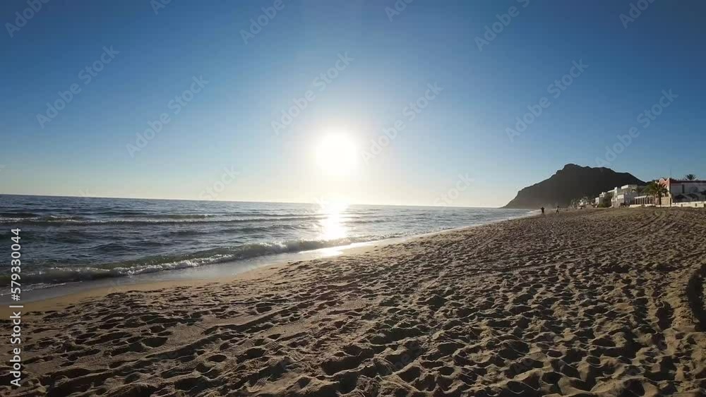 Drone flies taking off from the beach and flies above the waves of the sea Drone flies taking off from the beach and flies above the waves of the sea