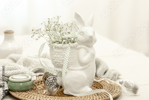 Easter composition with a ceramic hare and gypsophila flowers.