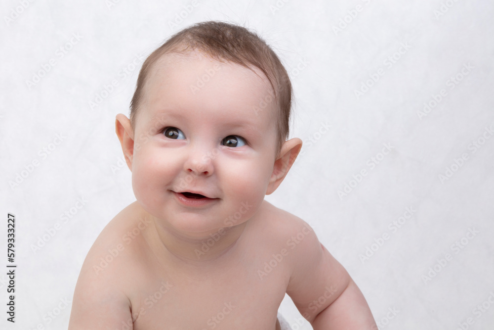 Six month old baby on a white background. Happy boy mid-range. Conceptual photo of fatherhood and motherhood.Alpha generation. Six month old baby on a white background. Happy boy mid-range. Conceptual photo of fatherhood and motherhood.Alpha generation.