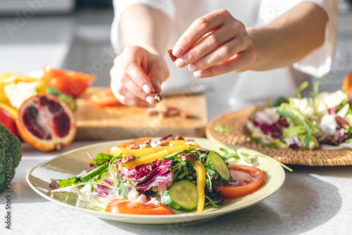 Wallpaper Mural A woman makes a fresh vegetable salad, close-up. Torontodigital.ca