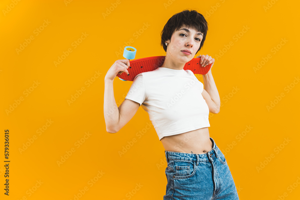 Female model in white top and jeans posing with a minoboard resting on her shoulders. Medium shot. High quality photo Female model in white top and jeans posing with a minoboard resting on her shoulders. Medium shot. High quality photo