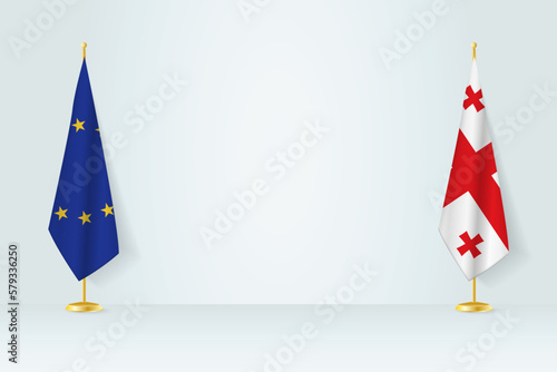 European Union and Georgia flag on indoor flagpole, meeting concept between Georgia and European Union.