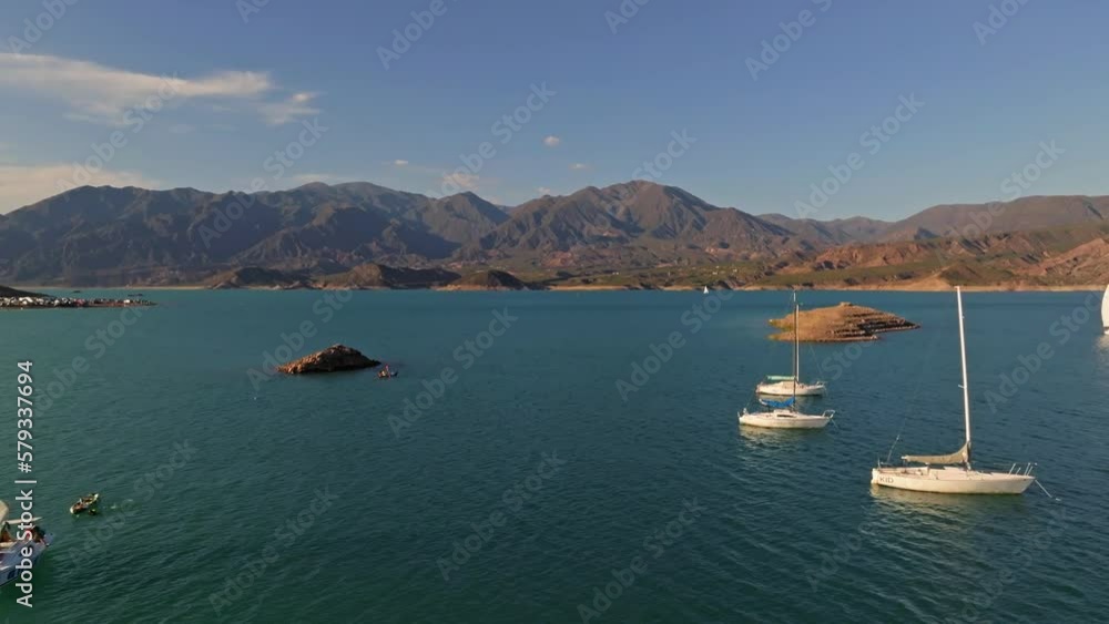 Backward aerial dolly shot revealing anchored sailboats in Mendoza, Argentina Backward aerial dolly shot revealing anchored sailboats in Mendoza, Argentina