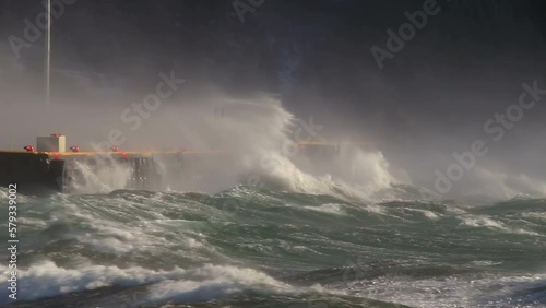 Powerful waves hitting docks Akureyri Iceland winter storm