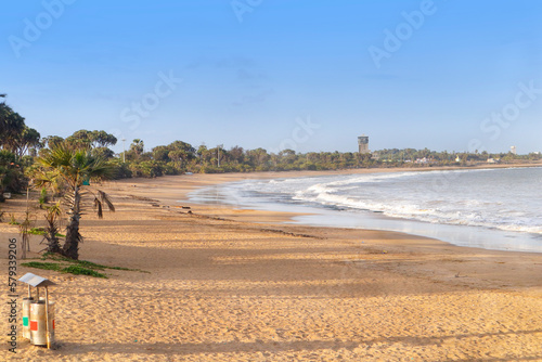 Beautiful empty sandy Nagaon beach with it's blue water in the distance at Diu, Gujarat, India. The brown muddy water and with a sandy beach. view of Arabian. The Indian ocean and iconic font of diu photo