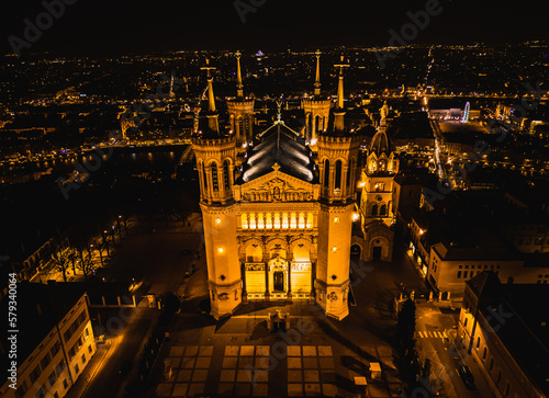 Panoramic aerial shot at night time of illuminated Basilica Notre Dame de Fourviere  photo