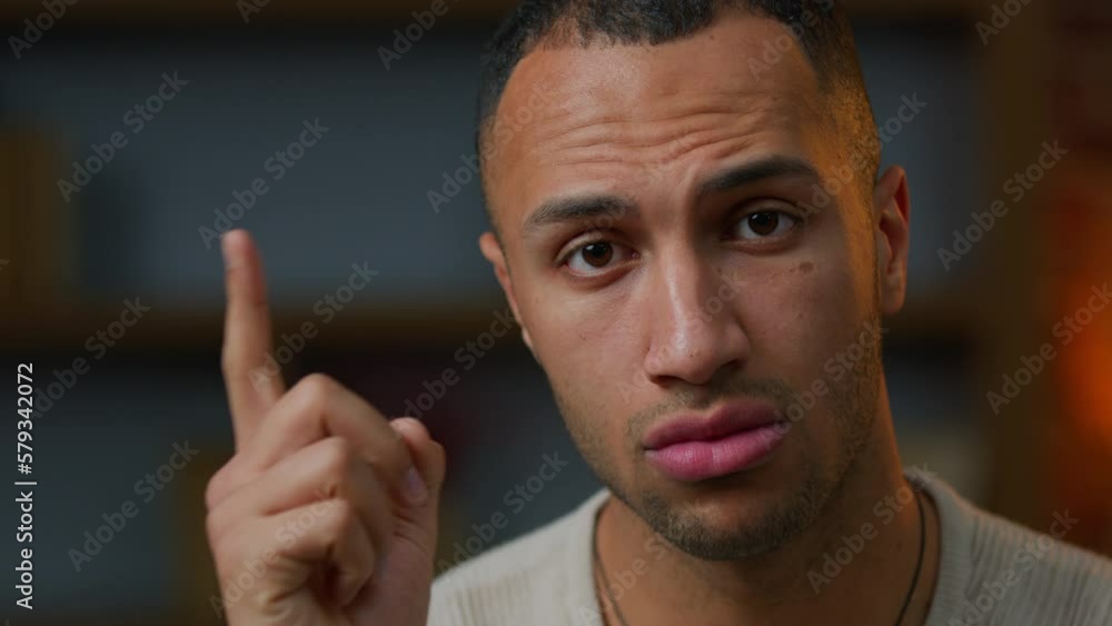 Portrait of African american latino male homeowner 30s man looking at camera shaking index finger warn gesture serious guy warning caution distrust disagree with idea bad choice prohibit threat forbid Portrait of African american latino male homeowner 30s man looking at camera shaking index finger warn gesture serious guy warning caution distrust disagree with idea bad choice prohibit threat forbid