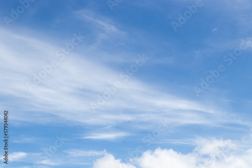Blue color sky with white fluffy cloud background