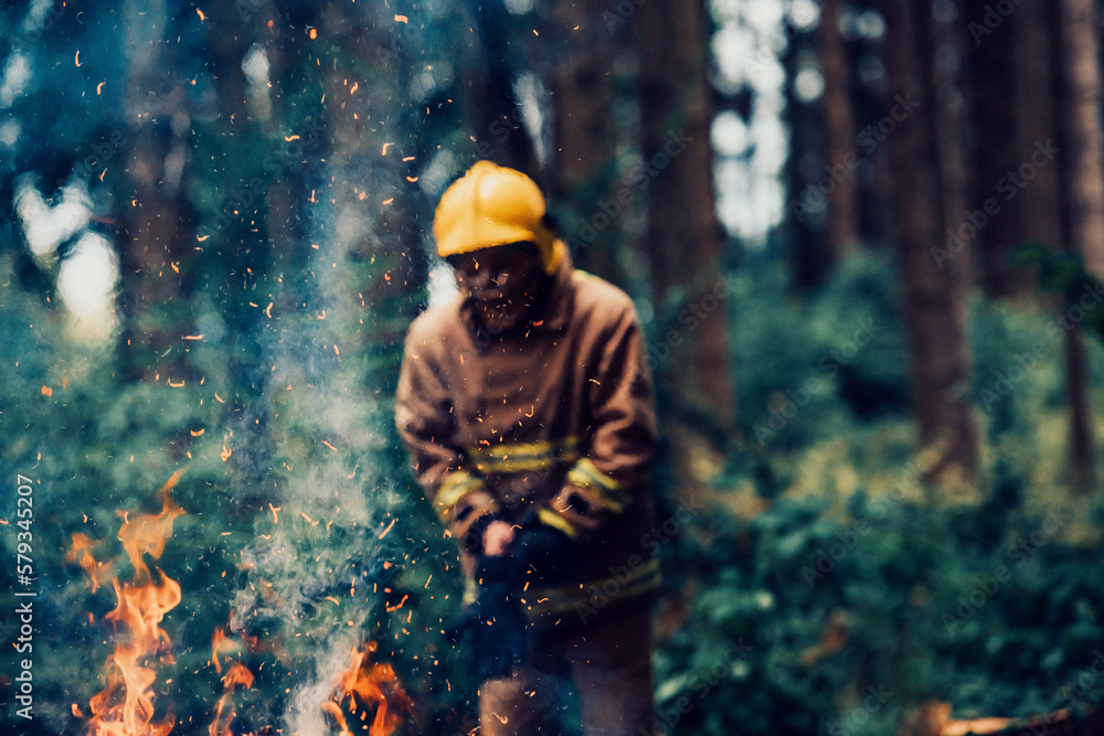 Firefighter at job. Firefighter in dangerous forest areas surrounded by strong fire. Concept of the work of the fire service Firefighter at job. Firefighter in dangerous forest areas surrounded by strong fire. Concept of the work of the fire service