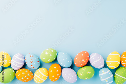 Photography Overhead easter eggs isolated on blue background with copy space, Funny decorati