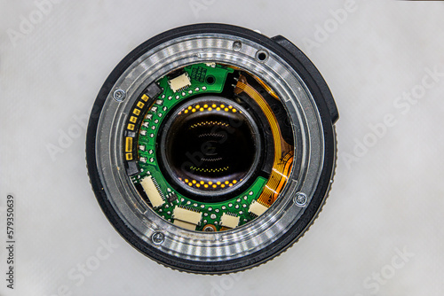 Chips and microcircuits in a camera lens on a white background	
 photo