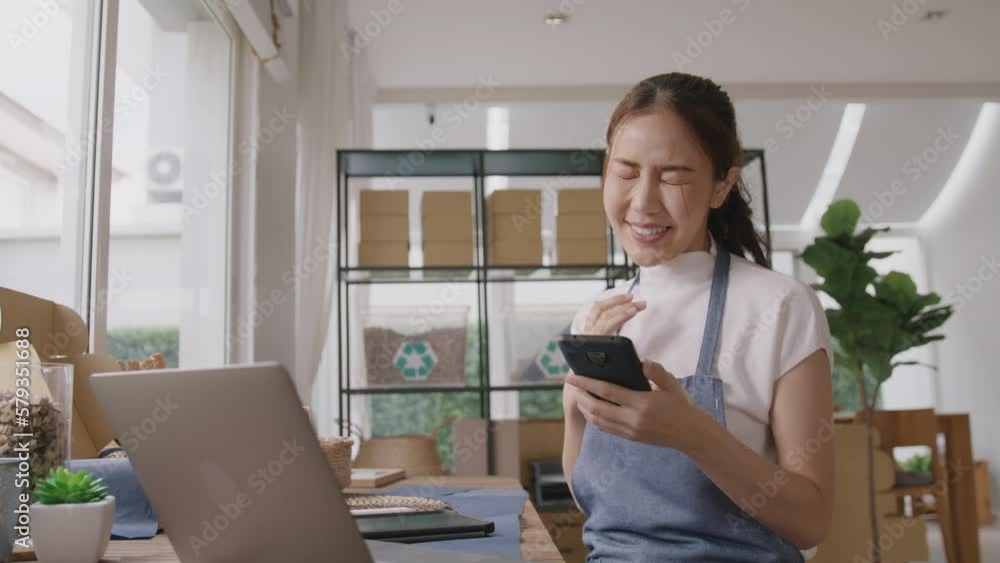Smart SME money lending for eco friendly online shop store. Young adult people asia woman happy smile looking at good news on phone joy win reward at home office. Winner ESG e-commerce startup vendor. Smart SME money lending for eco friendly online shop store. Young adult people asia woman happy smile looking at good news on phone joy win reward at home office. Winner ESG e-commerce startup vendor.