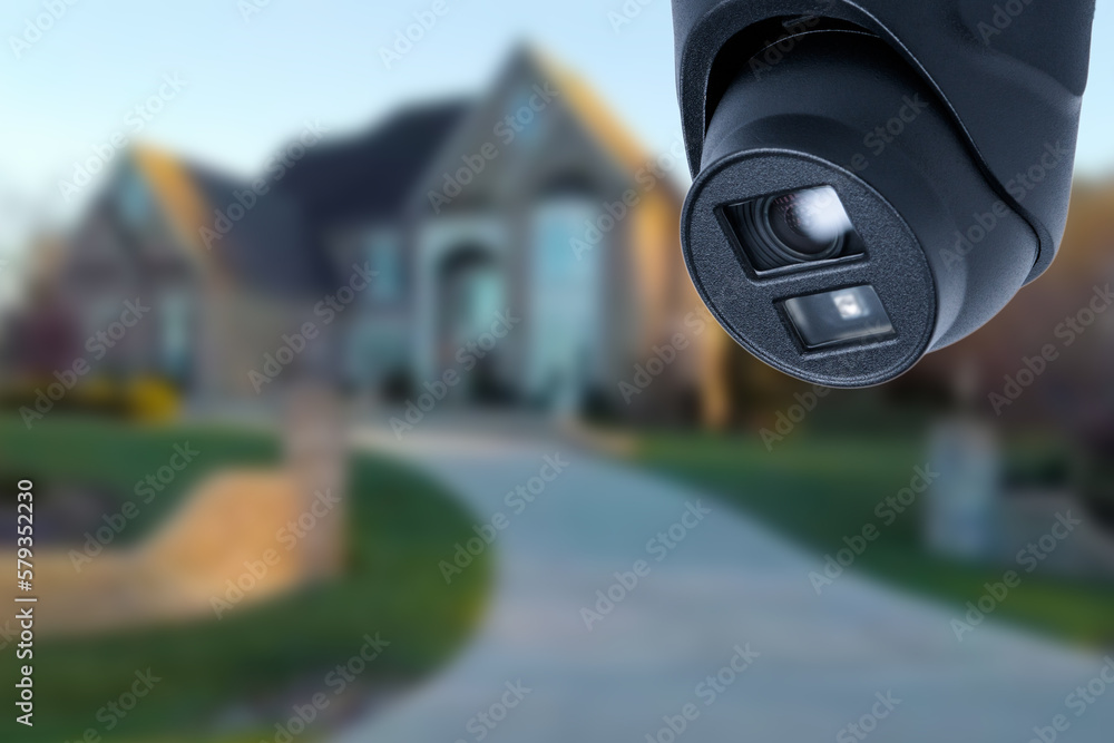 Fototapeta premium Security camera and private house on the background.