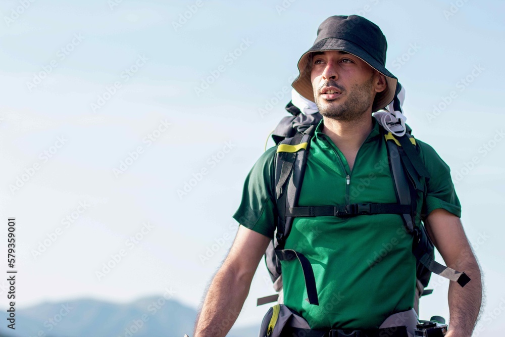 Man backpacking with mountain background and blue sky, alpine.
Mountain concept