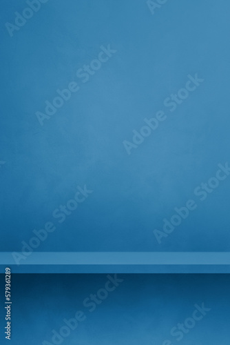 Empty shelf on a blue concrete wall. Background template. Vertical mockup