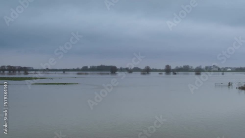 Ijssel river flooding with water running over the floodplains during flooding caused by high water levels after heavy rain in the river in Overijssel The Netherlands photo