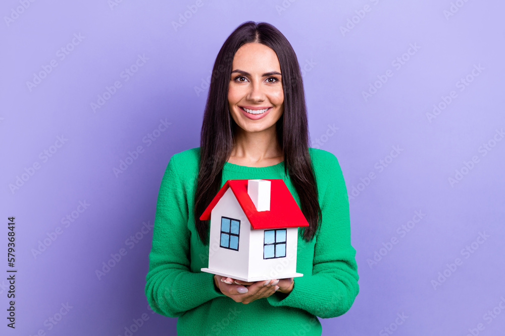 Photo of young positive smiling enjoy her life business lady hold first property owner buy new big house advert isolated on violet color background Photo of young positive smiling enjoy her life business lady hold first property owner buy new big house advert isolated on violet color background