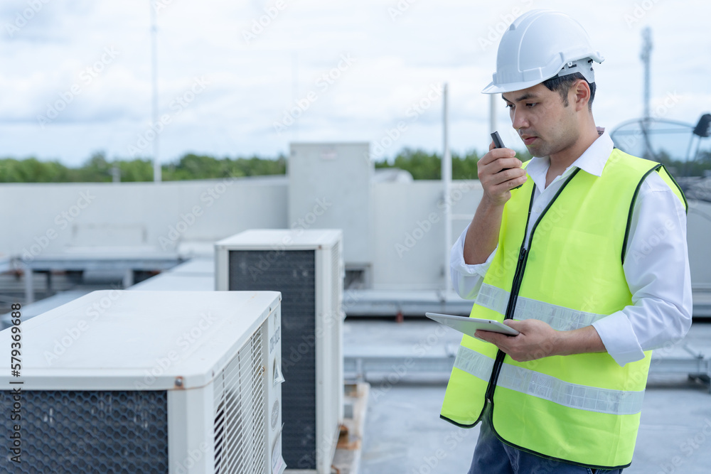 © Shisu_ka - Asian maintenance engineer works on the roof of factory. contractor inspect compressor system and plans installation of air condition systems in construction. technology, online checking, mobile app © Shisu_ka - Asian maintenance engineer works on the roof of factory. contractor inspect compressor system and plans installation of air condition systems in construction. technology, online checking, mobile app