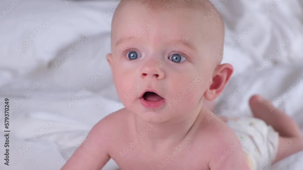 Cute boy 6 months old or half a year old on a light background Cute boy 6 months old or half a year old on a light background