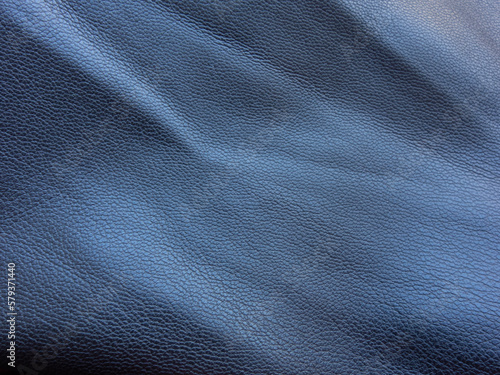 Detail of a black pleated leather garment