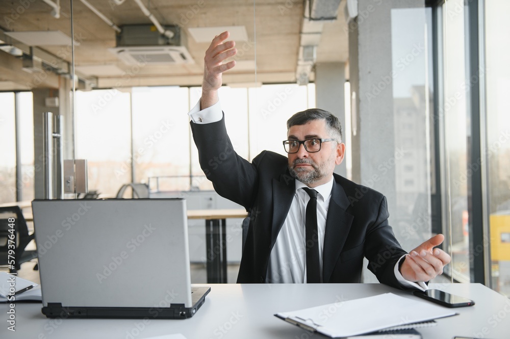 Angry businessman with document shouting at somebody Angry businessman with document shouting at somebody