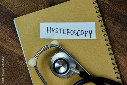 Concept of Hysteroscopy write on sticky notes with stethoscope isolated on Wooden Table. photo