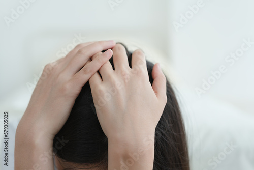 depressed woman holding head in hands 