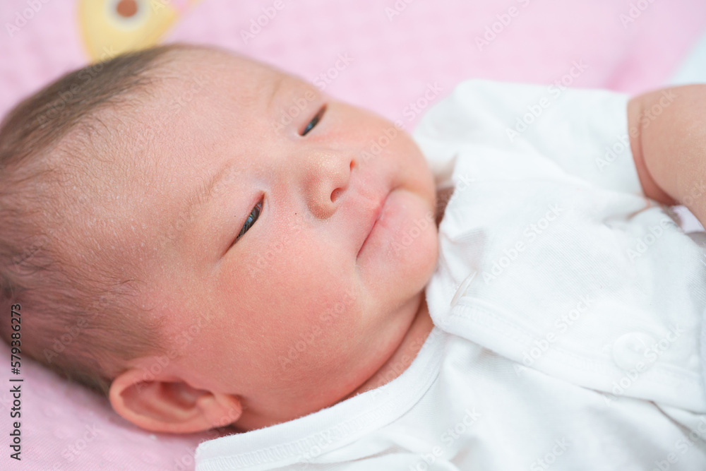 Portrait of a newborn Asian baby girl sleep on the bed , cute Fat baby 5 day,close up. Portrait of a newborn Asian baby girl sleep on the bed , cute Fat baby 5 day,close up.