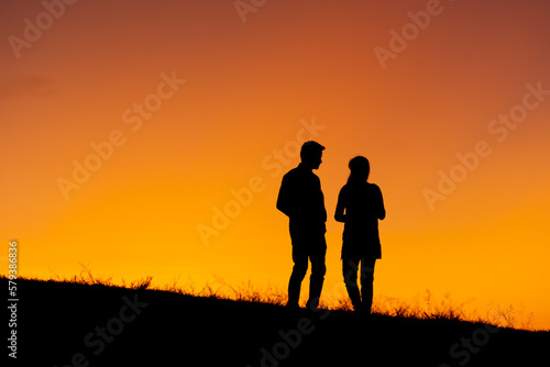 Silhouette of a couple in love at sunset background. Hadubai view point Ban Lao Wu, Wiang Haeng, Chiang Mai Copy space for use. Silhouette of lover on hill in sunset © somchairakin