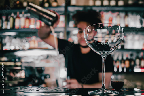 man hand bartender making cocktail in glass on the bar counter