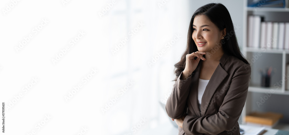 Portrait of young beautiful business woman standing in the modern office room. Portrait of young beautiful business woman standing in the modern office room.